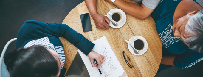 Top down view of meeting over coffee